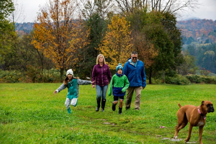 Jennifer and Ryan Cashman walk with their children, Morgan and Brady, and their dog Nova in Vermont