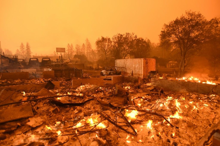 Businesses burn under a darkened smoky sky in Paradise, north of Sacramento, California in 2018