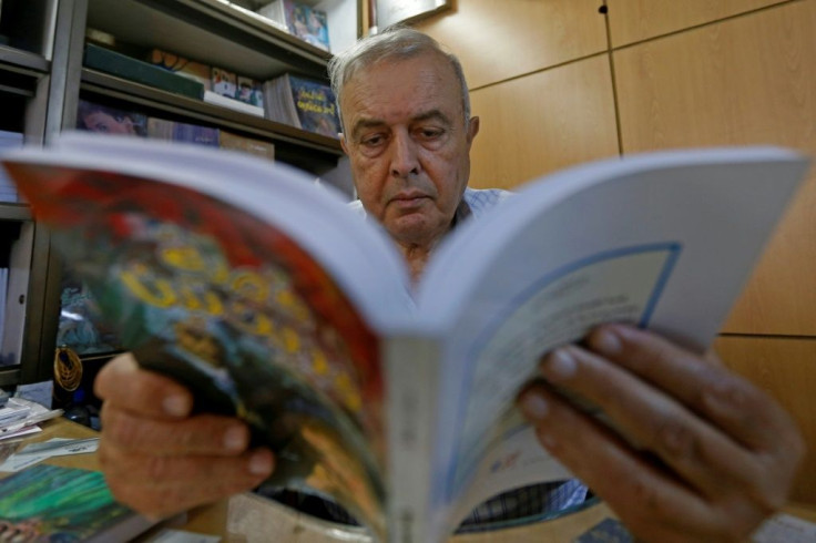 Khalil Haddad reads a book at the Dar Oussama publishing house in the Syrian capital Damascus