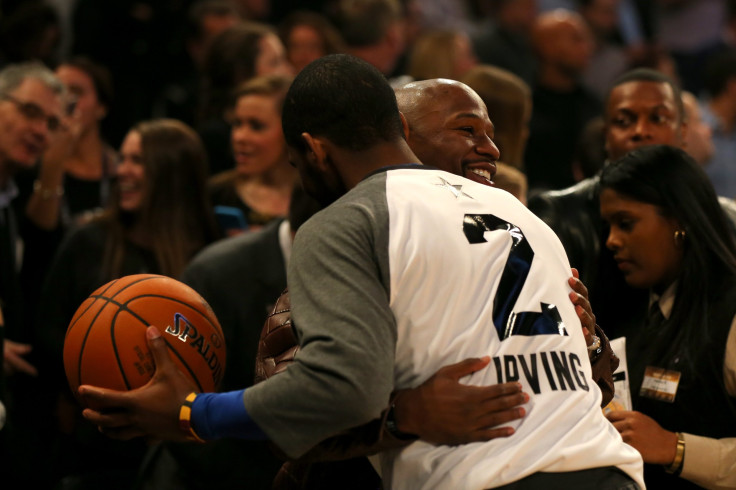  Kyrie Irving #2 of the Cleveland Cavaliers and the Eastern Conference hugs Boxer Floyd Mayweather Jr. 