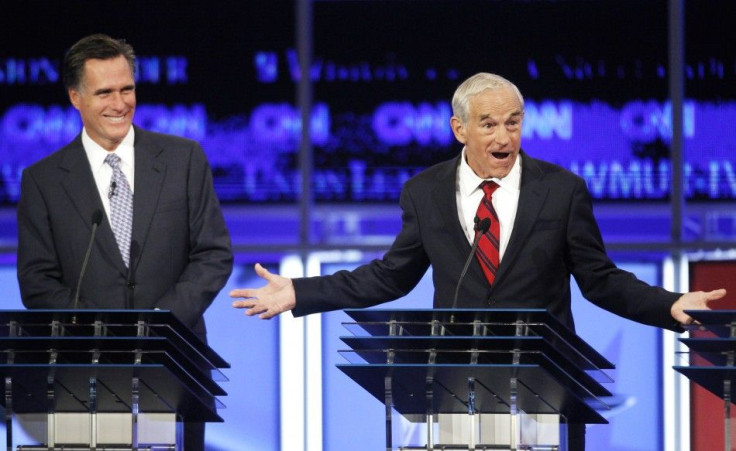 Republican presidential hopeful former Massachusetts Governor Mitt Romney (L) listens as U.S. Rep. Ron Paul (R-TX) makes a point at the first New Hampshire debate of the 2012 campaign in Manchester, New Hampshire