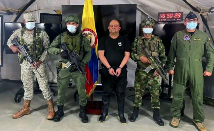 Soldiers in Bogota escort Colombia's most-wanted drug lord and head of the Gulf Clan, Dairo Antonio Usuga (centre), after his capture