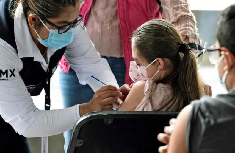 A minor is inoculated with the first dose of the Pfizer-BioNtech vaccine against the coronavirus