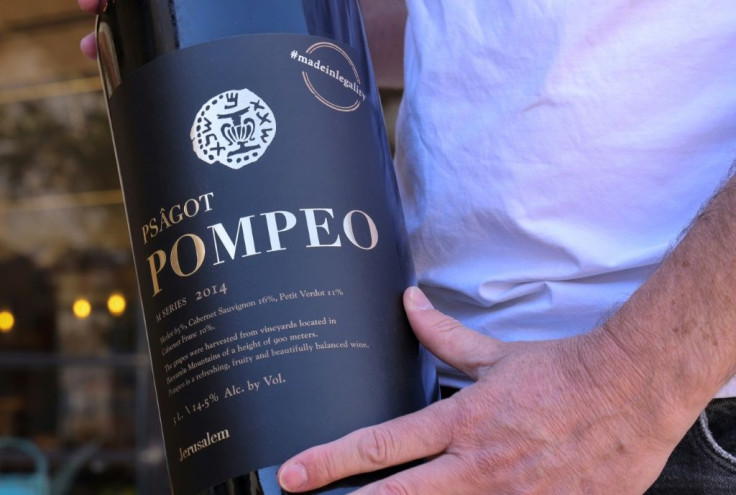 A winemaker holds a bottle of his red blend named after then US secretary of state Mike Pompeo at the Psagot Winery, a West Bank settlement he visited in November 2020