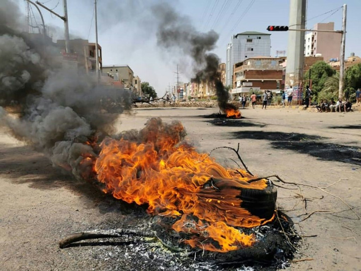 Smoke billows from burning tyres in Khartoum during a protest against the coup -- repression of protests could reignite the country's civil wars, an analyst said