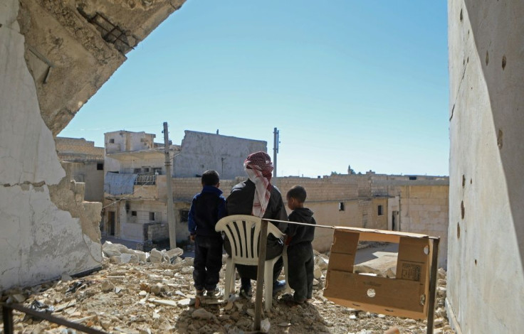 Syrian Khalil Ibrahim looks over a defacto border separating regime and rebel-held territory that cuts him off from his home