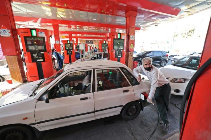 A man fills his car at a gas station in Tehran after disruptions that authorities blamed on a mysterious cyber attack