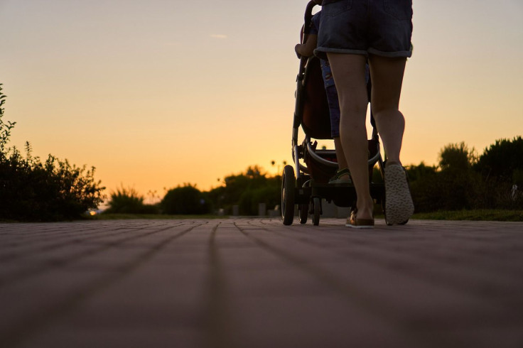 Mother/Woman Walking With Baby Stroller