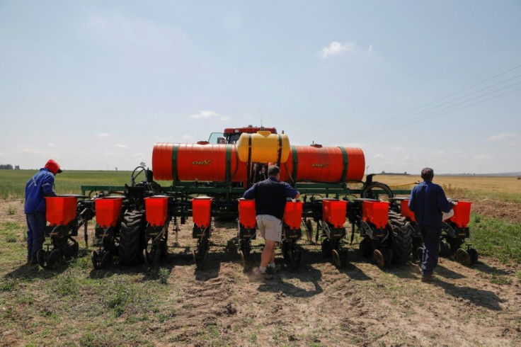 Bester, centre, checks soy seeds ahead of planting on his 1,100-hectare spread