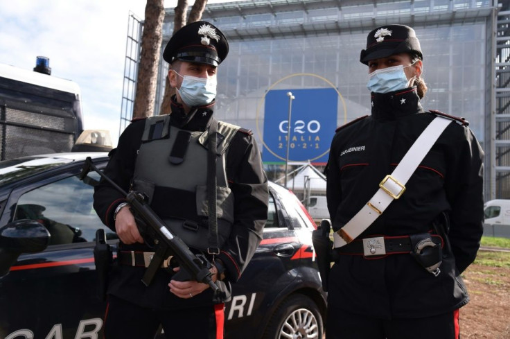 Carabinieri police officers stand guard outside the 'Nuvola' convention centre ahead of the G20 summit