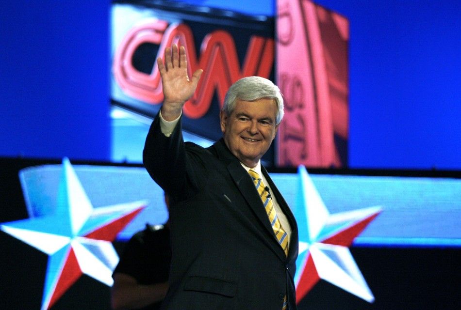 Republican presidential hopeful Newt Gingrich acknowledges supporters before the first New Hampshire debate of the 2012 campaign in Manchester