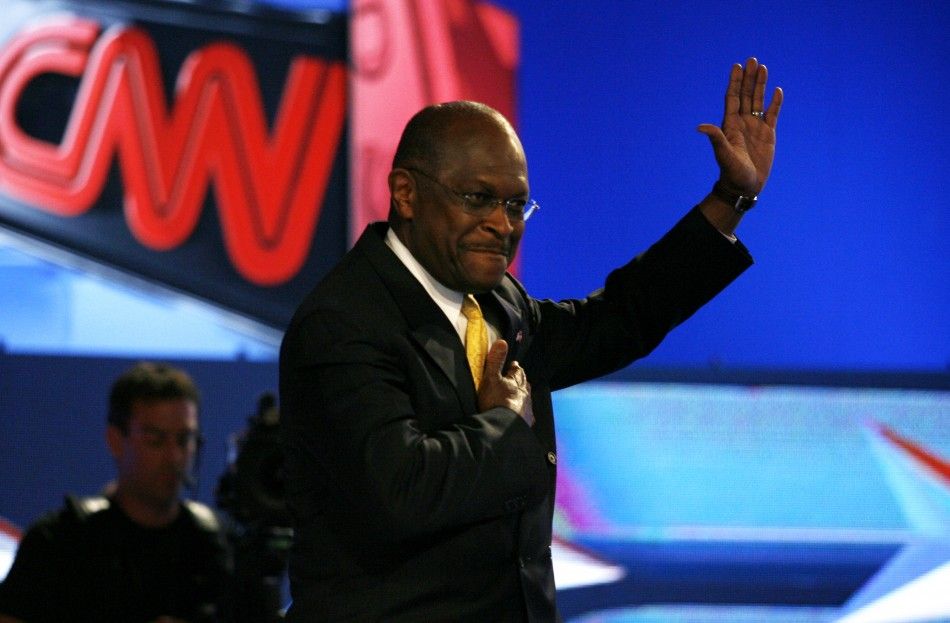 Republican presidential hopeful Herman Cain waves during photo opportunity before the first New Hampshire debate of the 2012 campaign in Manchester