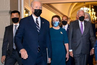 US President Joe Biden, followed by Speaker of the House Nancy Pelosi (C) and House Majority Leader Steny Hoyer (R), arrives at the US Capitol in Washington, DC, on October 28, 2021