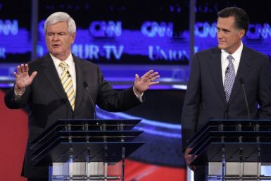 Former Speaker of the U.S. House of Representatives Newt Gingrich answers questions as former Massachusetts Governor Mitt Romney listens at the first New Hampshire debate of the 2012 campaign in Manchester, New Hampshire