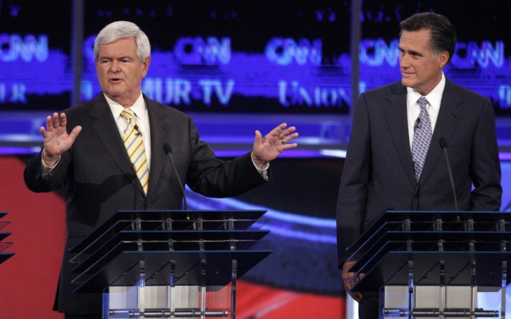 Former Speaker of the U.S. House of Representatives Newt Gingrich answers questions as former Massachusetts Governor Mitt Romney listens at the first New Hampshire debate of the 2012 campaign in Manchester, New Hampshire