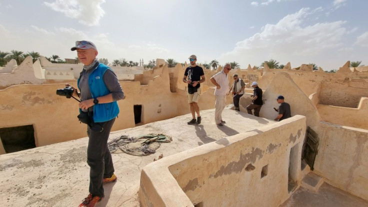European tourists, escorted by security personnel, visit the old town of Ghadames, a desert oasis some 650 kilometres (400 miles) southwest of the Libyan capital Tripoli