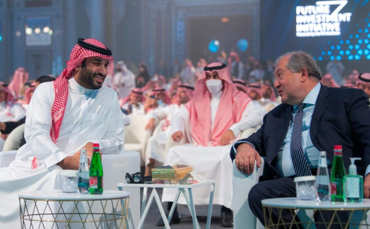 Saudi Crown Prince Mohammed bin Salman (L) makes a brief appearance at the Future Investment Initiative (FII) conference