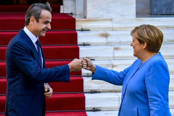 Greek Prime Minister Kyriakos Mitsotakis (L) called Merkel 'the voice of reason and stability'