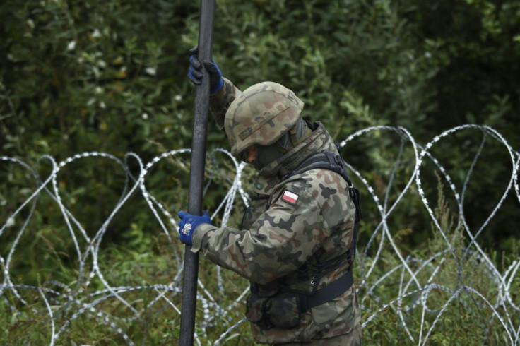 A Polish soldier worked on the construction of a barbed wire fence on the border with Belarus in Zubrzyca Wielka near Bialystok, eastern Poland on August 26, 2021