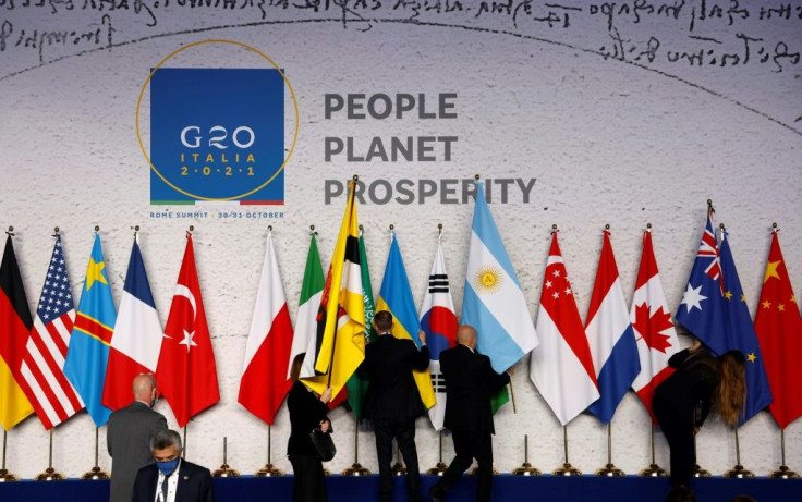 National flags are set out in final preparations for the official family photograph of world leaders at the G20 summit in Rome