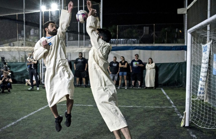 New members of the 'Maradonian Church' in Argentina re-enact late football star Diego Maradona's 'hand of God' goal scored in a World Cup match against England in 1986