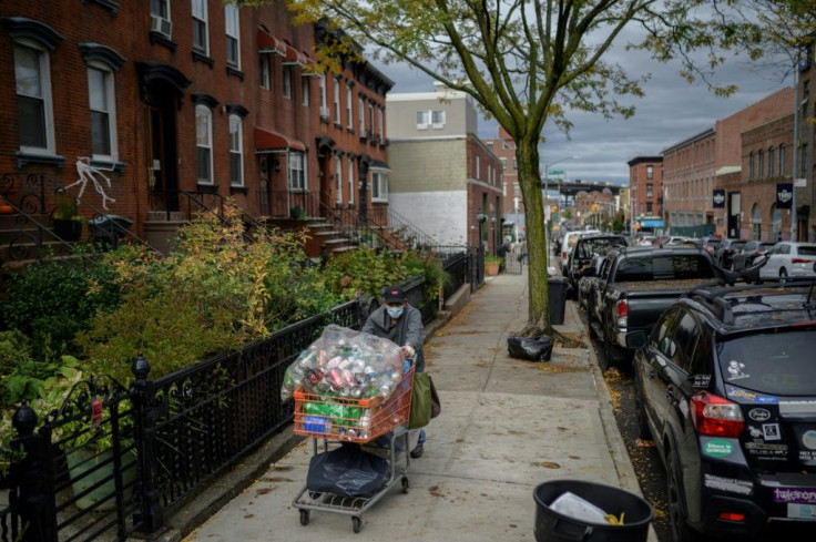Laurentino Marin drives his trolley of cans through the streets of Brooklyn in New York on October 27, 2021, before exchanging them for a few dollars at a recycling center