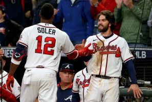Atlanta's Dansby Swanson, right, congratulates teammate Jorge Soler, left, after both hit home runs in the seventh inning to lift the Braves over Houston on Saturday in game four of the World Series