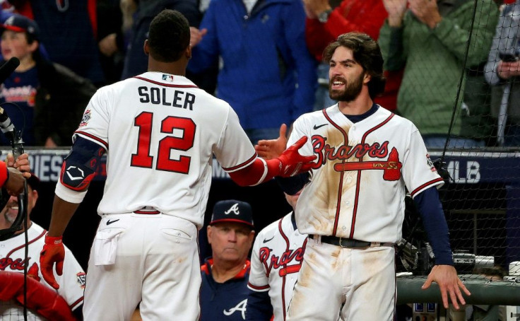 Atlanta's Dansby Swanson, right, congratulates teammate Jorge Soler, left, after both hit home runs in the seventh inning to lift the Braves over Houston on Saturday in game four of the World Series