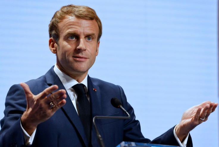 France's President Emmanuel Macron gestures as he addresses media at a press conference in Rome on October 31, 2021, during the G20 Summit