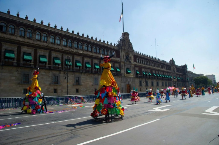 People take part in Mexico City's Day of the Dead parade, which returned in 2021 for the first time since the pandemic began