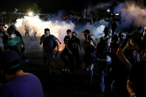 Police in Kenosha, Wisconsin are seen firing tear gas during race-related protests on August 25, 2020