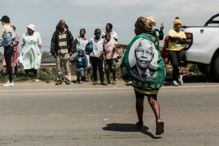 Fading glory: an ANC supporter sports a Mandela shawl but graft and unrest tarnish today's party