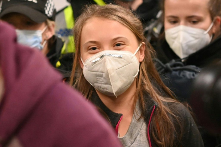 Swedish climate activist Greta Thunberg, wearing a face mask, arrives at Central station in Glasgow, Scotland