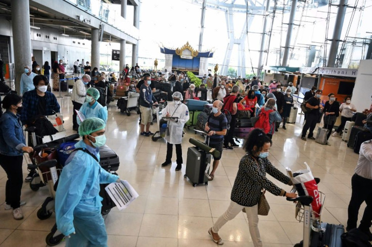 International tourists await instructions from health officials at Bangkok's Suvarnabhumi International Airport