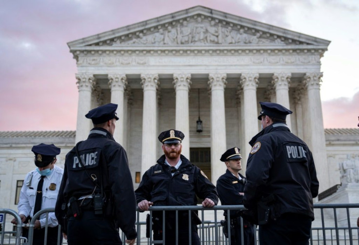 Police officers stand by security barricades set up outside the US Supreme Court ahead of legal challenges to a restrictive abortion law passed by Texas