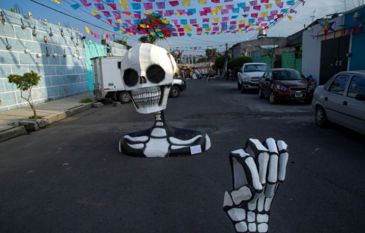 A giant skull made of cardboard is seen in the Santa Cecilia neighborhood in Mexico City to mark the Day of the Dead