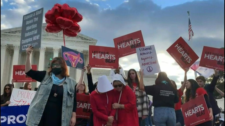 Protesters gather outside the US Supreme Court during a hearing on the Texas anti-abortion law