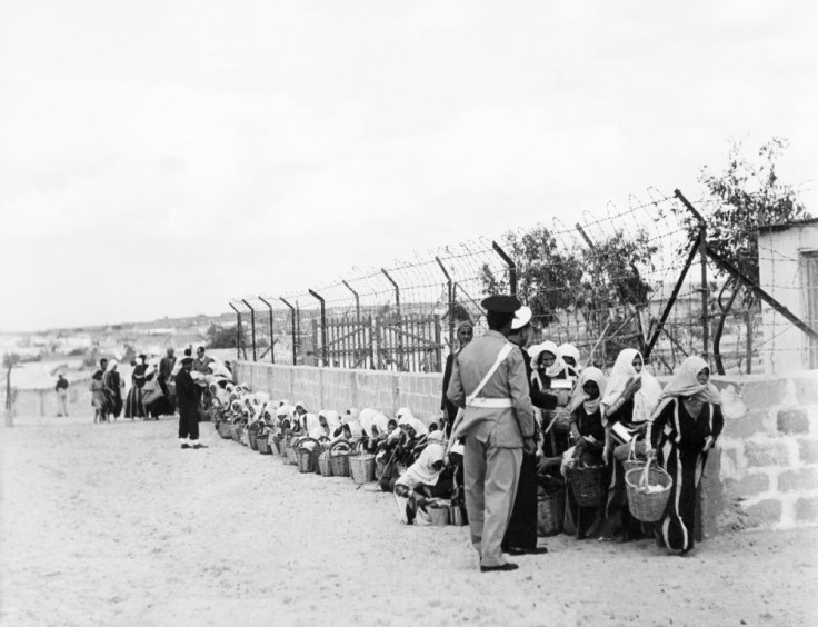 Palestinian refugees queue for food distributed by the UNRWA (United Nations Relief and Works Agency for Palestinian refugees) at a camp in Gaza on November 9, 1956