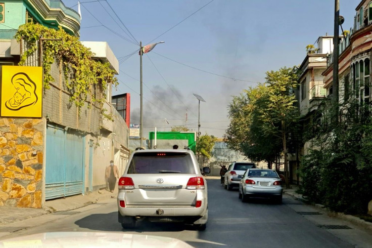 Smoke billows into the Kabul sky after the blasts near the military hospital