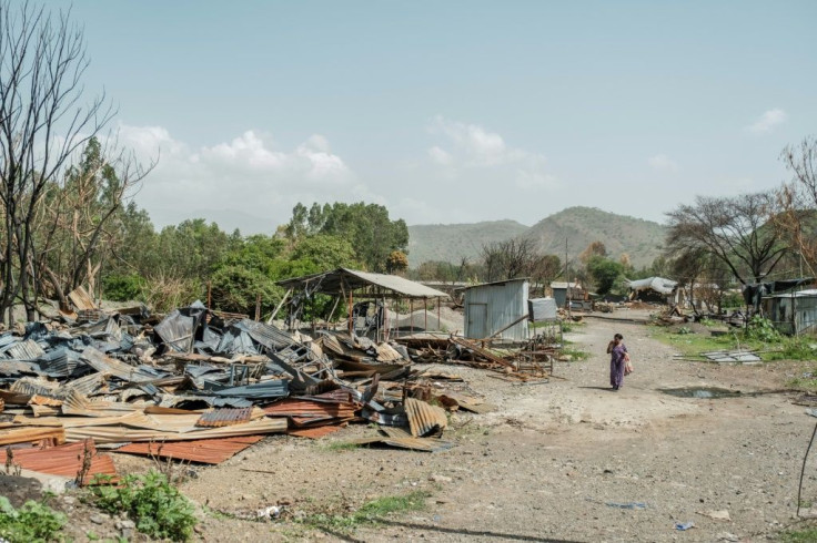 A woman walks amid the remains of a destroyed factory in Ataye, Ethiopia, on May 15, 2021