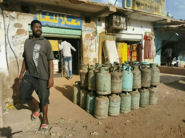 A man walks past gas cylinders in Sudan's capital Khartoum on November 2, 2021 as talks to broker peace between rival factions continue