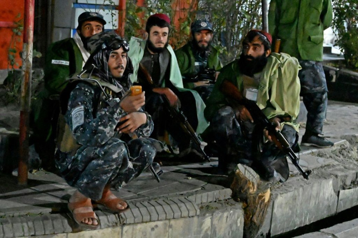 Taliban fighters near a military hospital targeted by IS-K