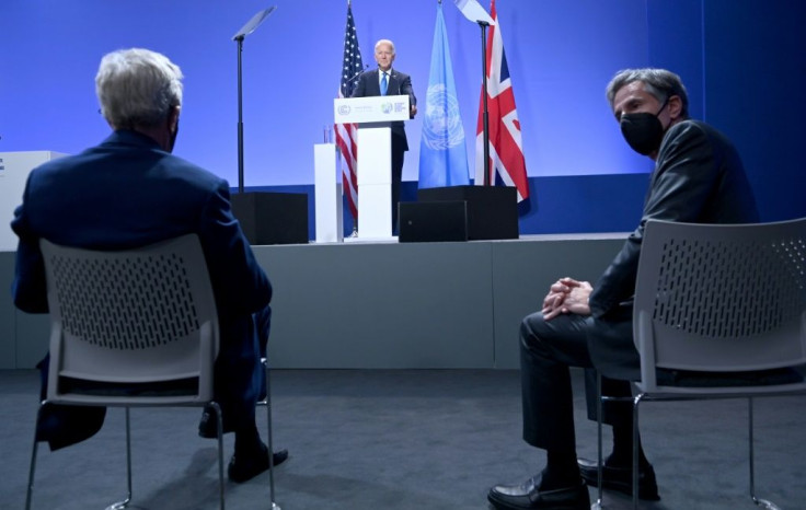 US Secretary of State Antony Blinken (R) looks on as President Joe Biden addresses a press conference at the UN COP26 climate summit in Glasgow