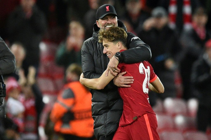 Liverpool manager Jurgen Klopp hugs Kostas Tsimikas after the 2-0 win over Atletico Madrid