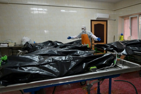 In the hospital's morgue, rows of bodies in black plastic bags testify to the deadly surge in infections