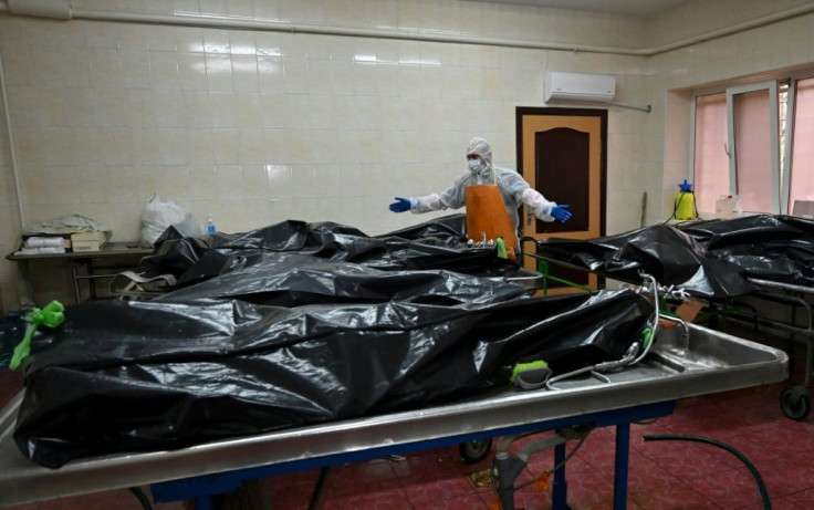 In the hospital's morgue, rows of bodies in black plastic bags testify to the deadly surge in infections