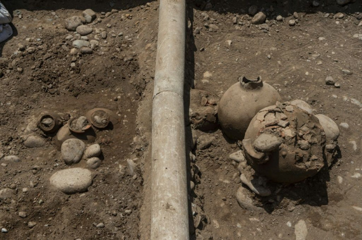 A work crew laying a natural gas pipe under a street in Lima, Peru stumbled across a 2,000-year-old burial site, including the remains of six people and ceramic vessels