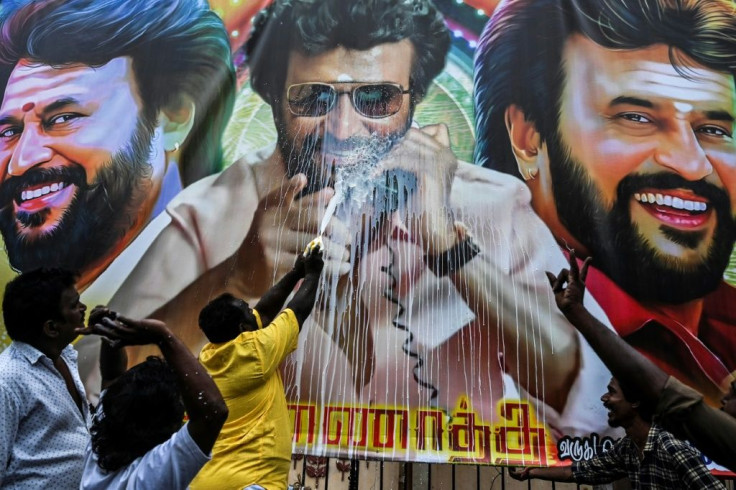 Fans in Tamil Nadu  excited about the movie 'Annaatthe' spray milk on a poster displaying Rajinikanth as a sign of respect for the actor