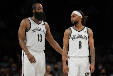 James Harden #13 talks with Patty Mills #8 of the Brooklyn Nets