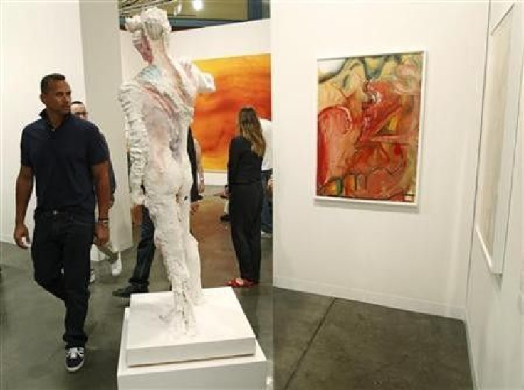 New York Yankees baseball player Alex Rodriquez (L) looks at artwork during a preview of the Art Basel Miami Beach art show at the Miami Beach Convention Center December 1, 2010.